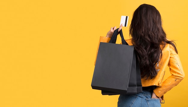 Young woman in yellow leather jacket copy space