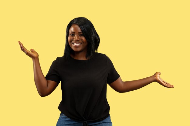 Young woman on yellow studio