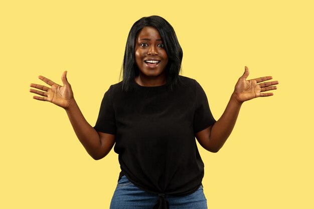 Young woman on yellow studio