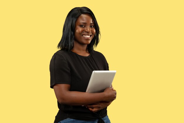 Young woman on yellow studio