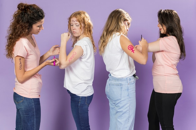 Young women activists painting for protest