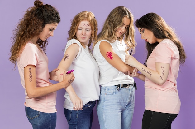 Young women activists painting for protest