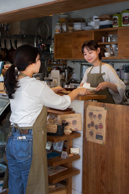 Young women arranging their cake shop