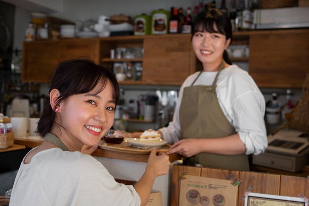 Young women arranging their cake shop