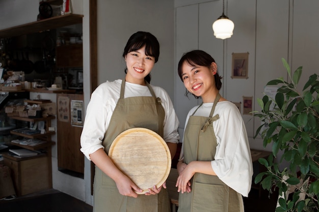 Young women arranging their cake shop