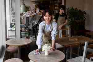 Free photo young women arranging their cake shop