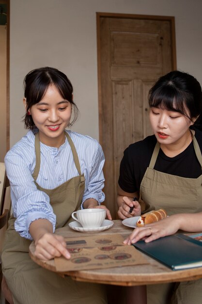 Young women arranging their cake shop