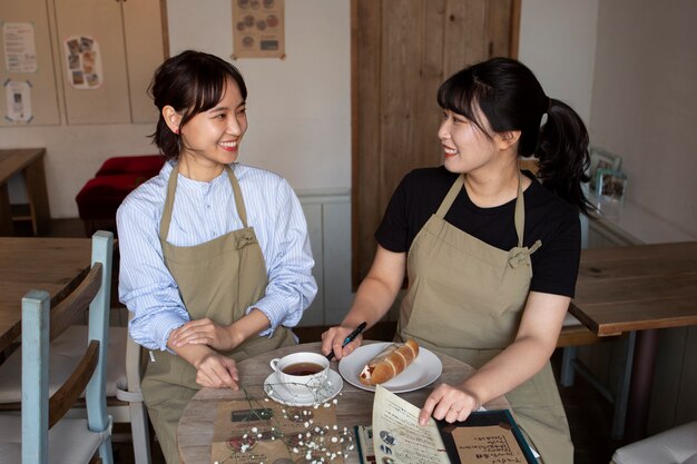 Young women arranging their cake shop