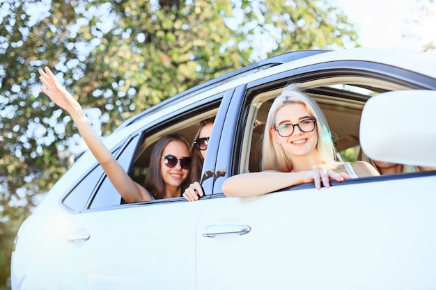 The young women in the car smiling