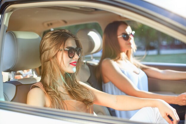 Young women in the car smiling
