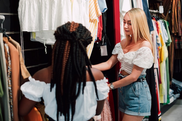 Young women checking clothing store