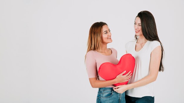 Young women couple with heart