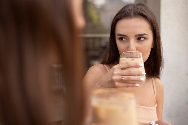 Young women drinking iced coffee