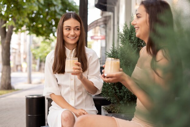 Young women drinking iced coffee