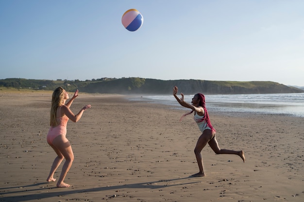 Молодые женщины веселятся на пляже