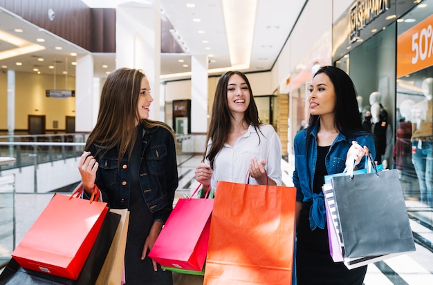 Young women having fun in shopping mall