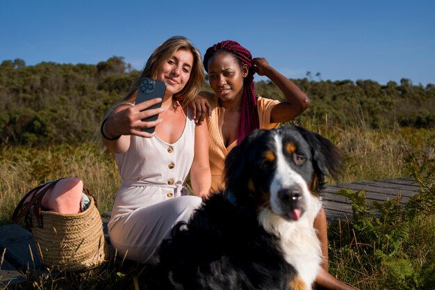 Young women having fun with  dog at the beach