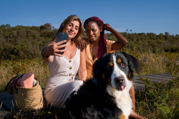 Young women having fun with  dog at the beach