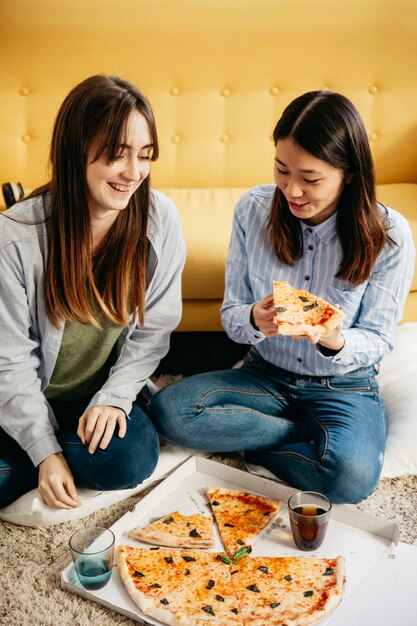 Young women having pizza party