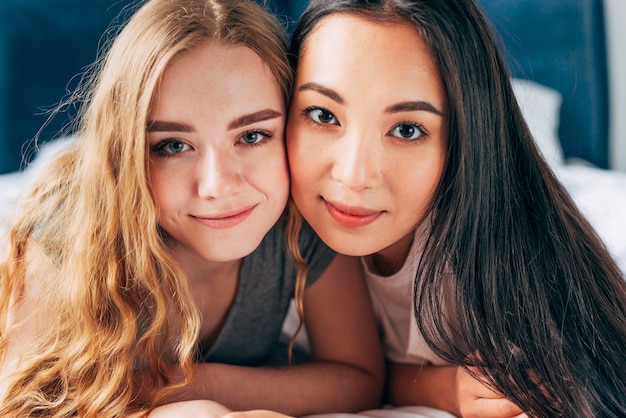 Young women hugging and looking at camera