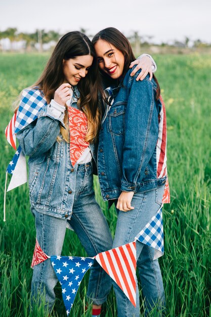 Young women laughing outside and hugging