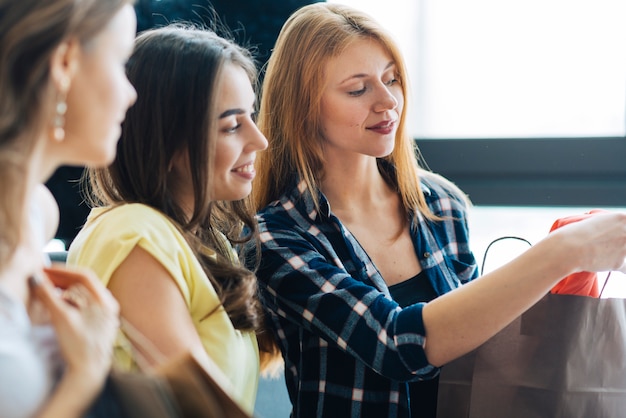 Young women looking at purchases together