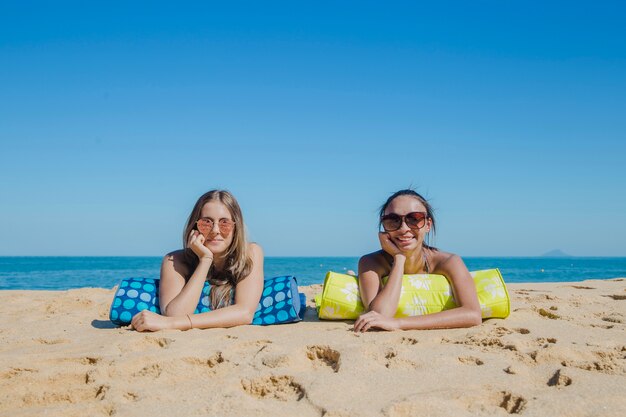 young women lying at the beach