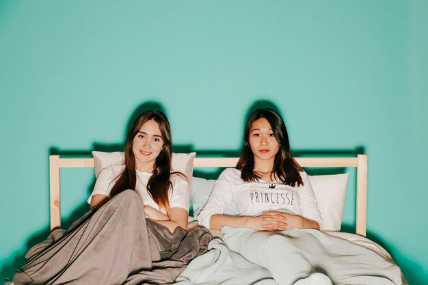 Young women lying in bed