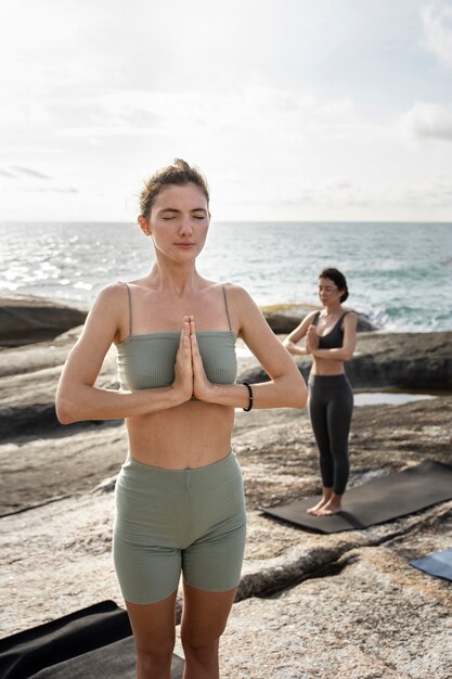 Young women meditating together