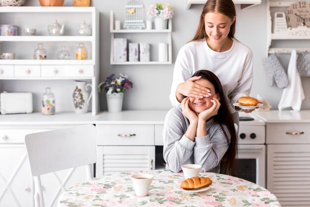 Young women playing in the kitchen