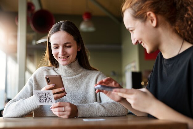 Young women scanning qr code at the cafeteria