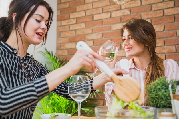 Young women sitting at table and talking