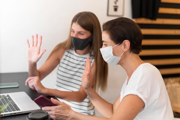 Young women at terrace wearing mask