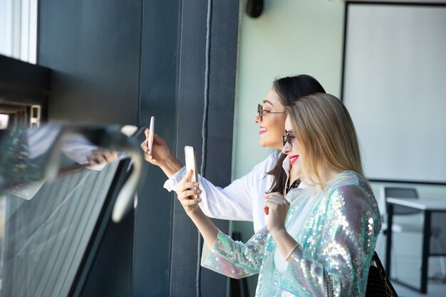 Young women waiting for departure in airport traveler with small baggage influencers lifestyle