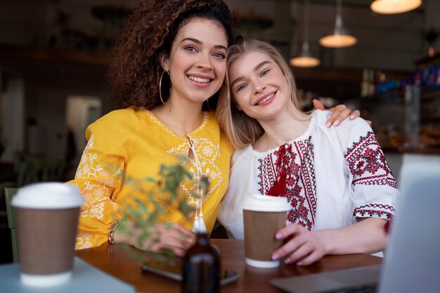 Young women wearing embroidered shirts