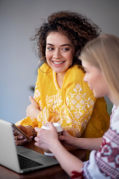 Free photo young women wearing embroidered shirts