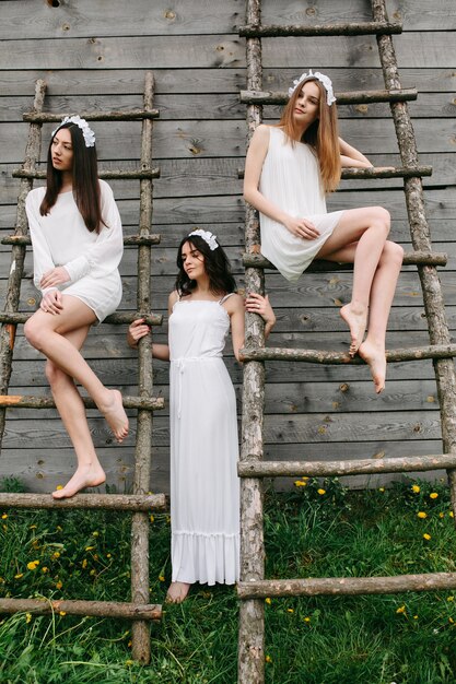 Young women wearing white dresses outdoors