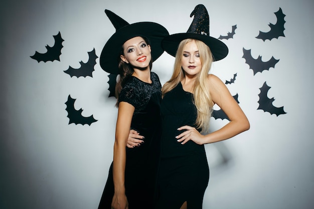 Young women wearing witch hats on Halloween