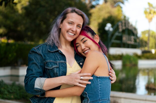 Young women with dyed hair near lake