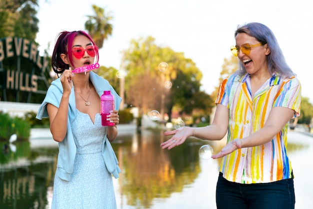 Young women with dyed hair near lake