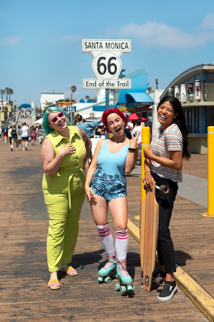 Young women with dyed hair near seaside