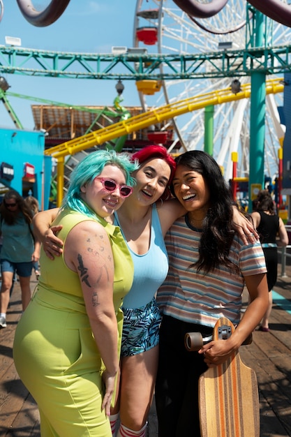 Free photo young women with dyed hair near seaside