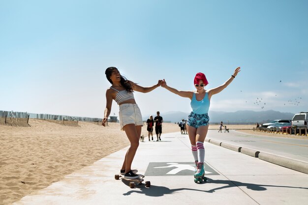 Young women with dyed hair near seaside