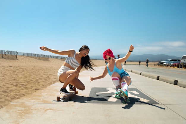 Young women with dyed hair near seaside