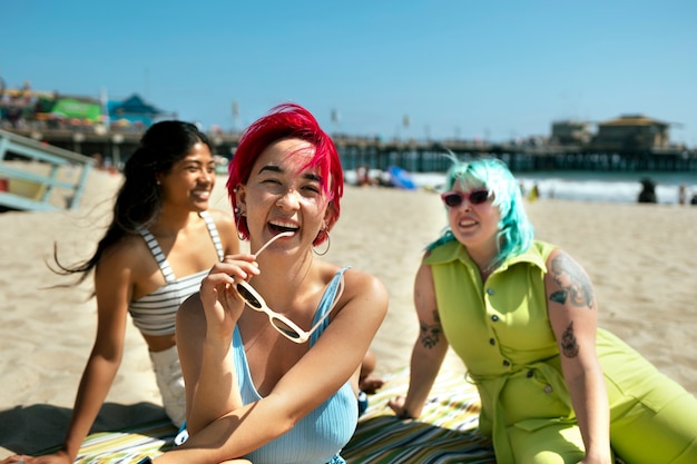 Young women with dyed hair near seaside