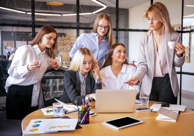 Young women at work planning together