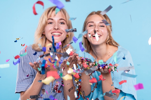 Young womens having fun with confetti