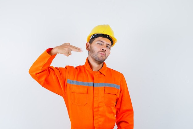 Young worker in uniform gesturing with hand and fingers and looking confident.