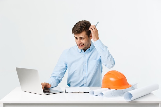 Young workman annoyed angry in furious gesture. Negative expression on white grey background.