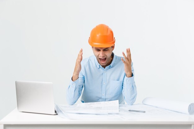 Young workman annoyed angry in furious gesture. Negative expression on white grey background.